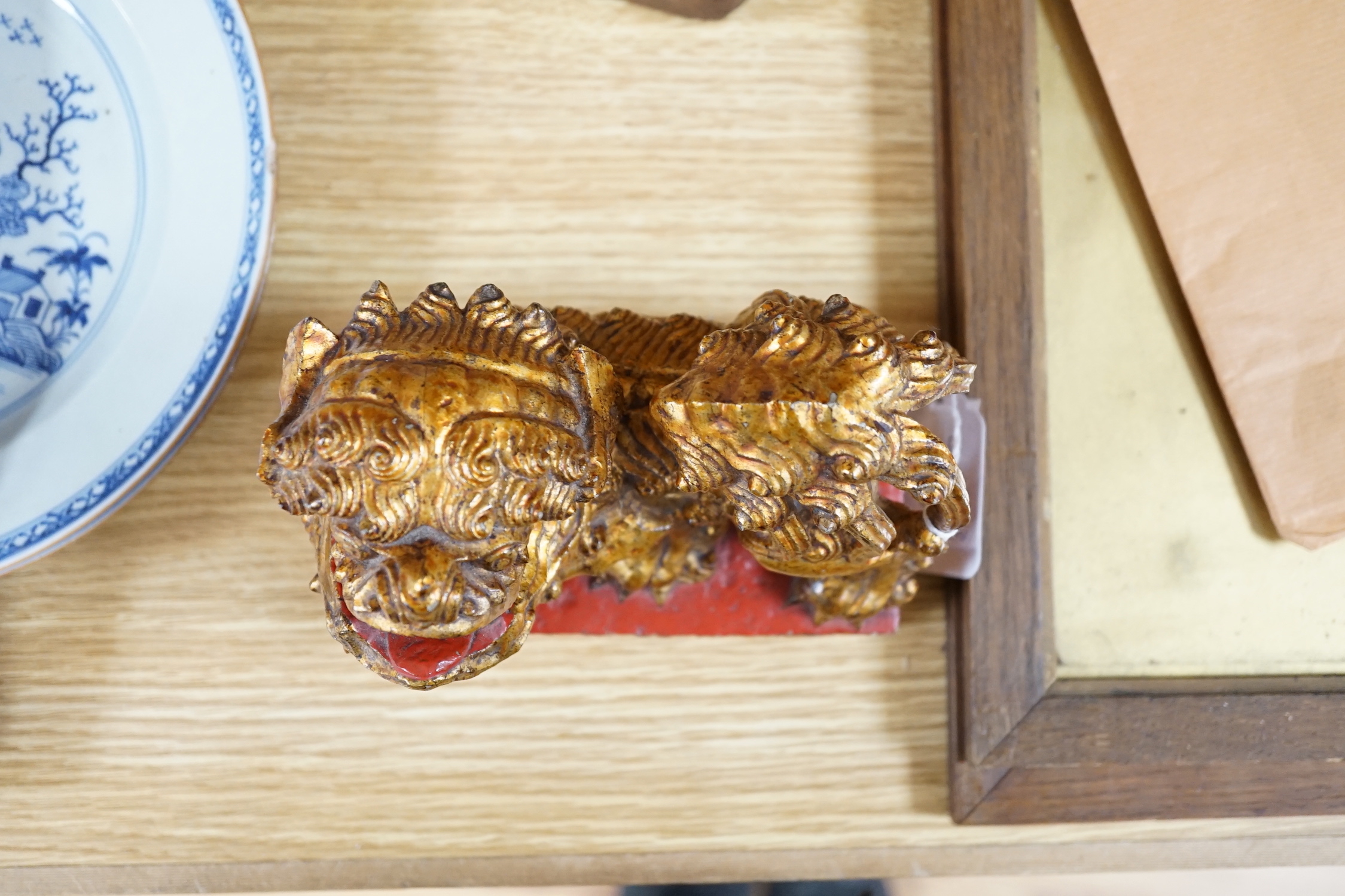 A Chinese lacquered wood figure of a seated woman and a Buddhist lion, tallest 20.5cm